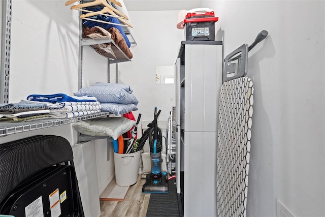 laundry area featuring light wood-type flooring