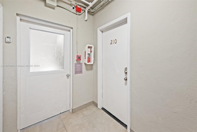 doorway to outside featuring light tile patterned flooring