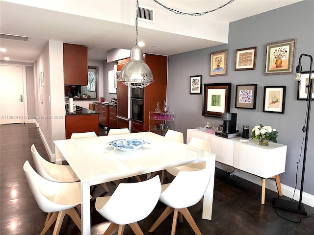 dining space with dark wood-type flooring