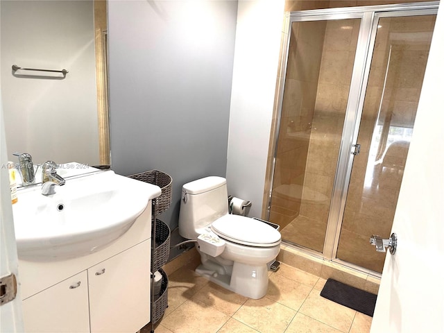 bathroom featuring vanity, tile patterned flooring, toilet, and an enclosed shower