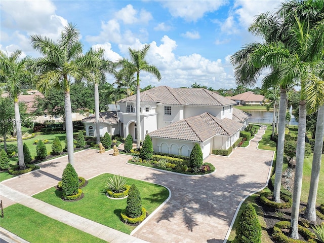 mediterranean / spanish-style home with a front lawn and a garage