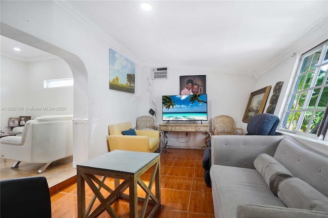 living room featuring ornamental molding, a wall mounted AC, and a wealth of natural light