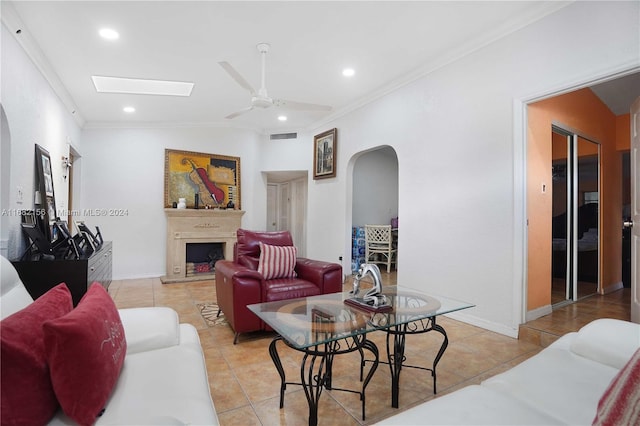 living room with crown molding, light tile patterned floors, and ceiling fan