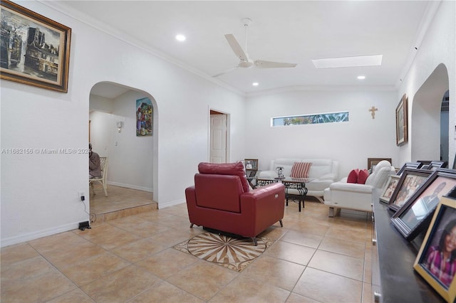 living room with crown molding, ceiling fan, lofted ceiling, and light tile patterned floors