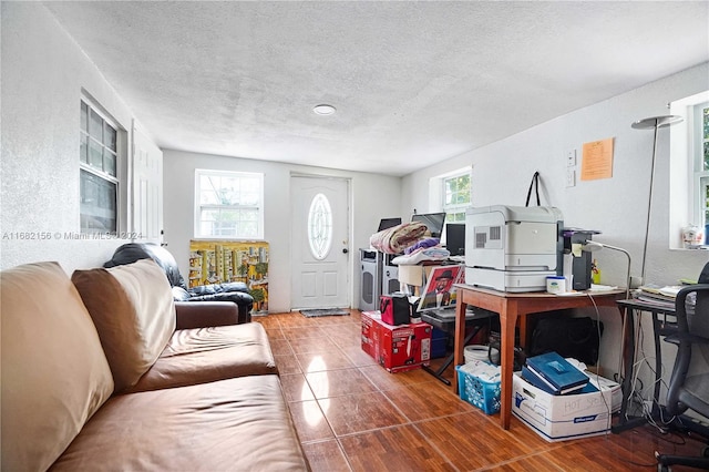 living room featuring a textured ceiling and tile patterned flooring