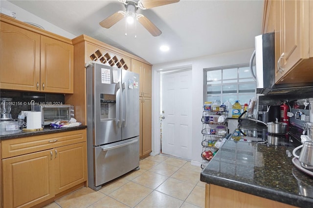 kitchen with tasteful backsplash, appliances with stainless steel finishes, ceiling fan, vaulted ceiling, and light tile patterned floors