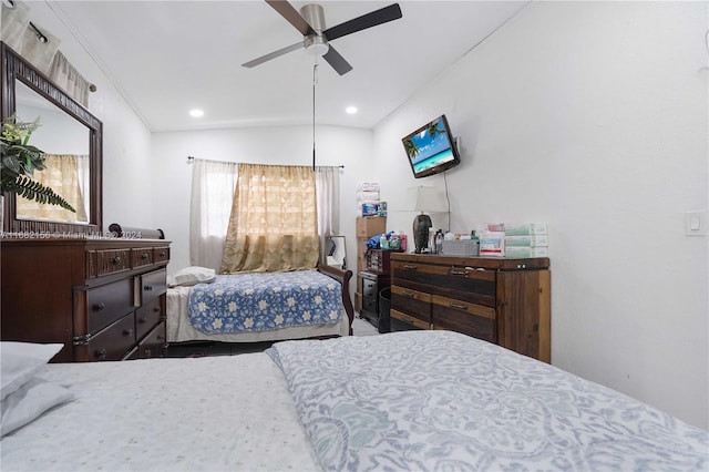 bedroom with ceiling fan, ornamental molding, and vaulted ceiling