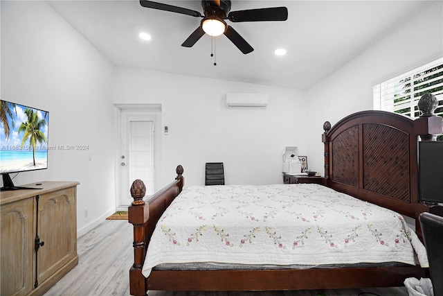 bedroom featuring a wall mounted air conditioner, vaulted ceiling, light wood-type flooring, and ceiling fan