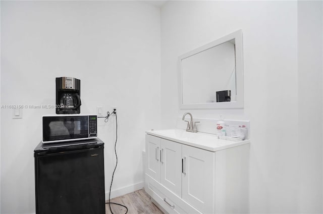 bathroom featuring vanity and hardwood / wood-style floors