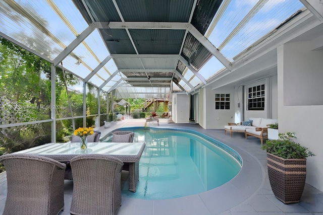 view of pool with a patio area and a lanai