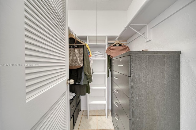 walk in closet featuring light tile patterned floors