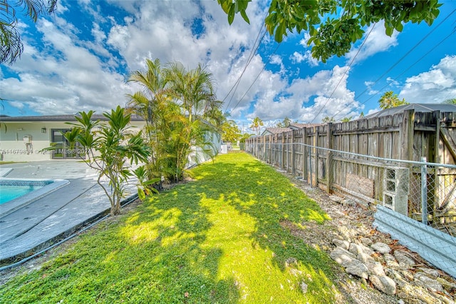 view of yard featuring a patio and a fenced in pool