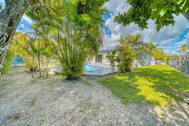 view of yard with a fenced in pool