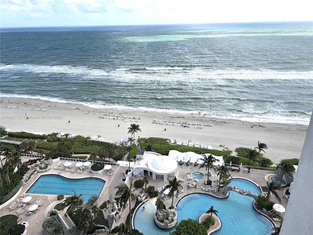 drone / aerial view featuring a water view and a view of the beach