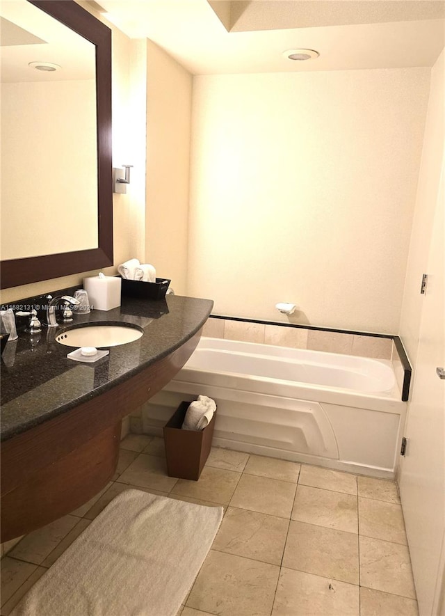 bathroom with sink, tile patterned flooring, and a washtub