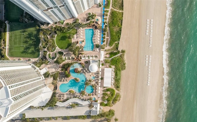 aerial view with a water view and a beach view