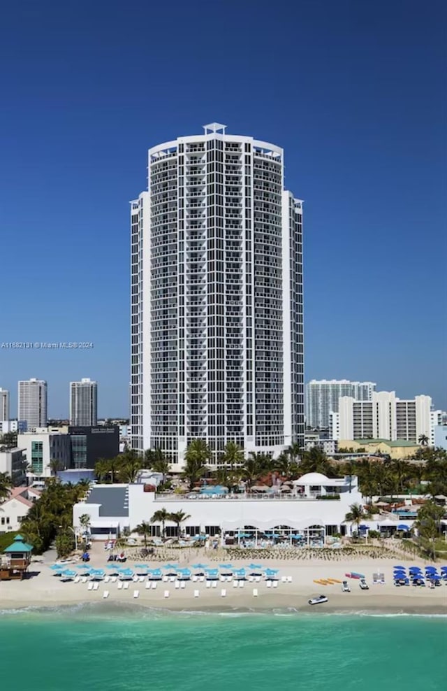 view of property with a water view and a view of the beach