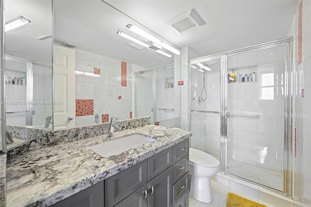 bathroom featuring toilet, walk in shower, vanity, and tile patterned floors