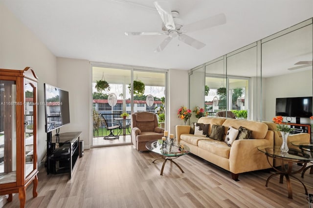 living room featuring light hardwood / wood-style flooring and ceiling fan