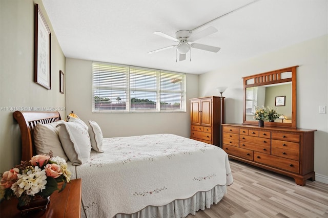 bedroom with light hardwood / wood-style flooring and ceiling fan