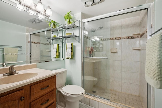 bathroom featuring vanity, toilet, and an enclosed shower