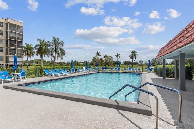 view of swimming pool with a patio