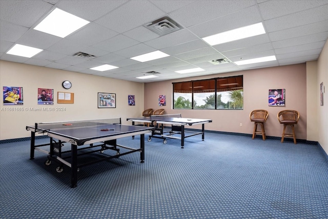 game room with a drop ceiling and carpet flooring