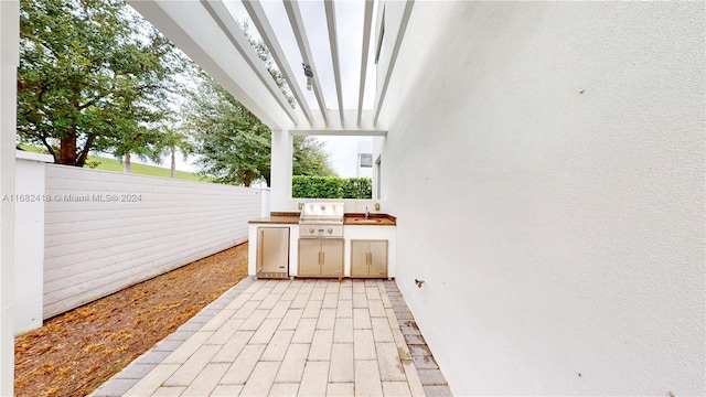 view of patio with sink and grilling area