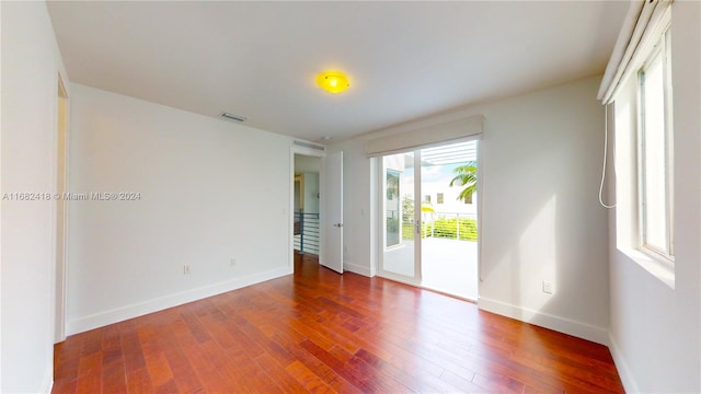 unfurnished room featuring dark hardwood / wood-style flooring