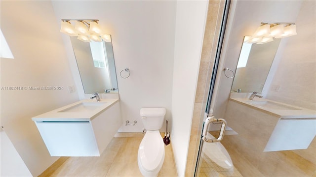 bathroom featuring vanity, toilet, an enclosed shower, and hardwood / wood-style floors