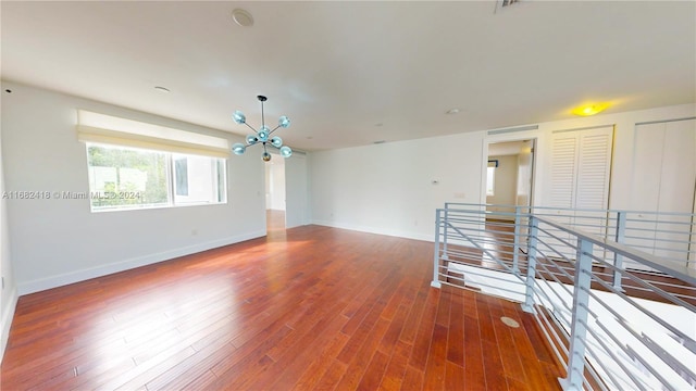 tiled empty room featuring a chandelier