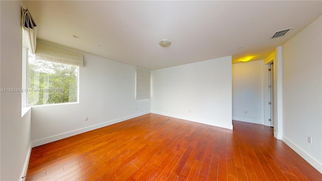 unfurnished room featuring hardwood / wood-style flooring