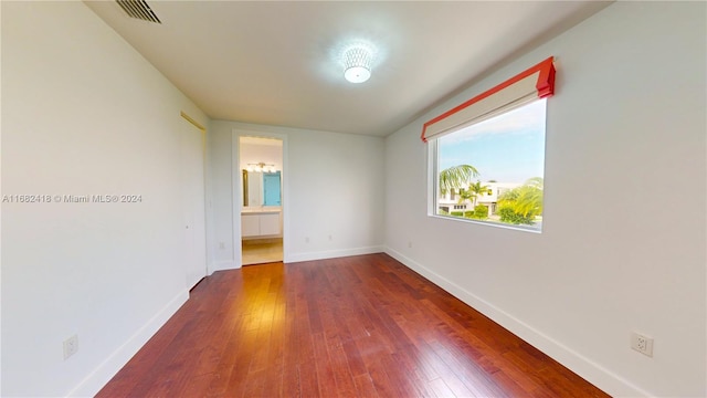 spare room with dark wood-type flooring