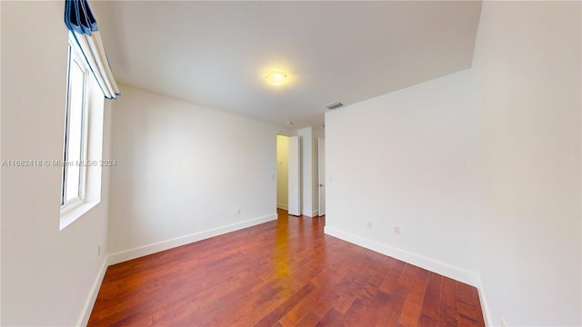 unfurnished room featuring dark hardwood / wood-style floors