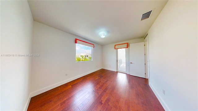 unfurnished room featuring dark hardwood / wood-style floors