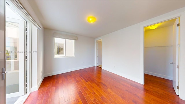 spare room featuring dark hardwood / wood-style flooring