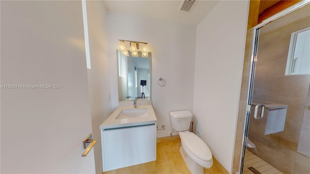 bathroom with vanity, toilet, walk in shower, and tile patterned flooring