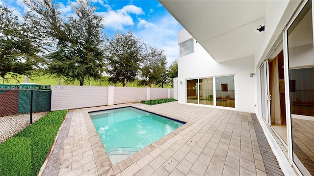 view of swimming pool featuring a patio area