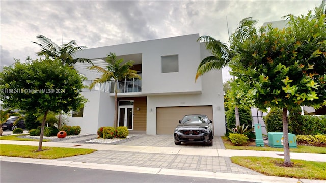 view of front of property with a balcony and a garage