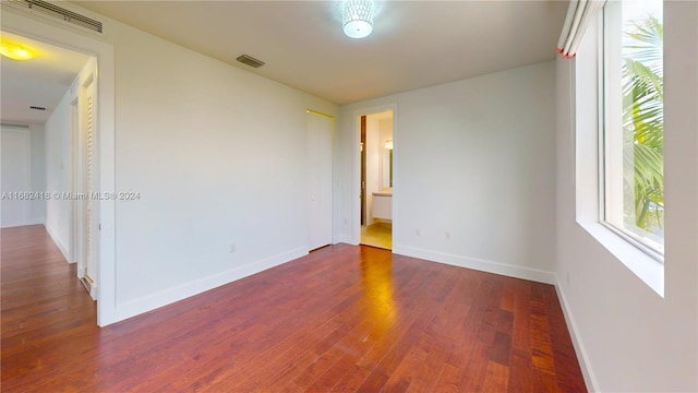 spare room featuring dark wood-type flooring