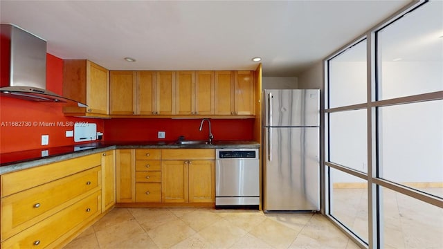 kitchen featuring appliances with stainless steel finishes, sink, and wall chimney exhaust hood