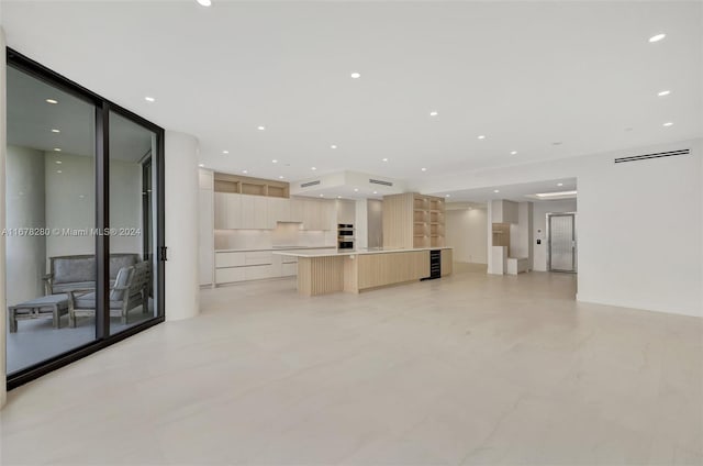unfurnished living room featuring recessed lighting