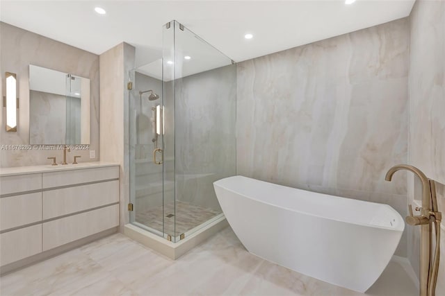 bathroom featuring tile walls, vanity, and shower with separate bathtub