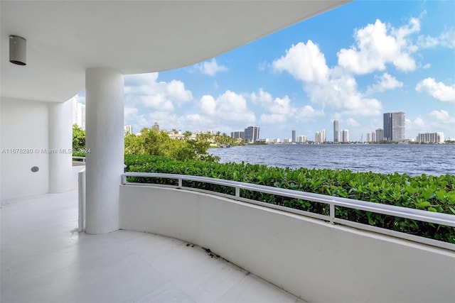 balcony with a water view and a city view