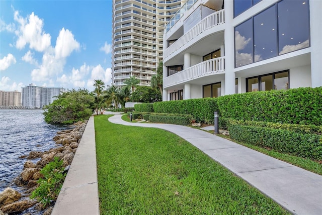 surrounding community featuring a water view and a yard
