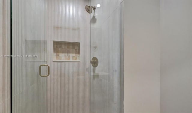 bathroom featuring a shower with shower door