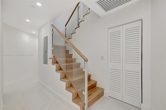 stairs with electric panel, visible vents, baseboards, marble finish floor, and recessed lighting