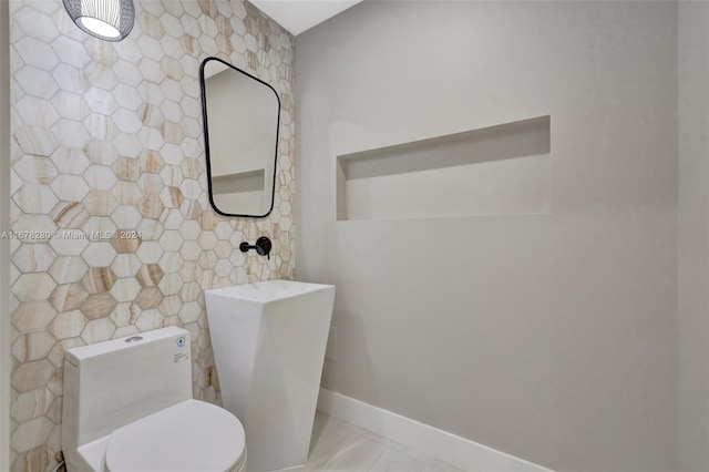 bathroom with toilet and tile patterned floors