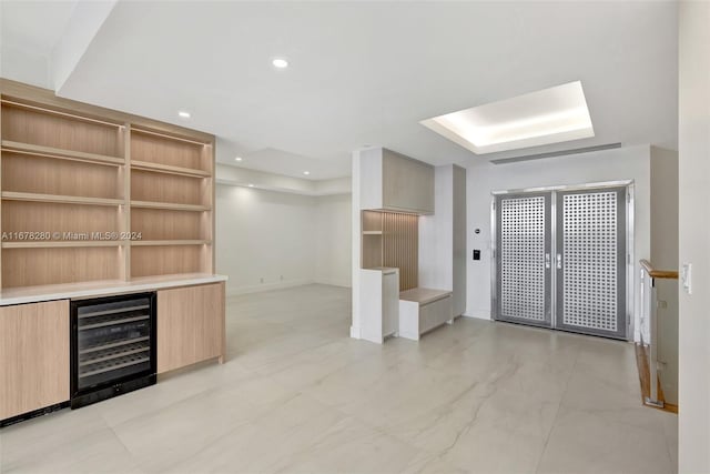 interior space featuring wine cooler and light brown cabinets