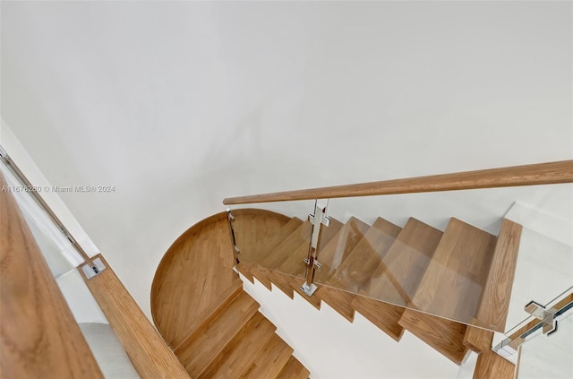 stairway featuring wood-type flooring